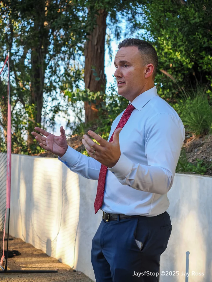 Tim speaking with guests at an outdoor event
